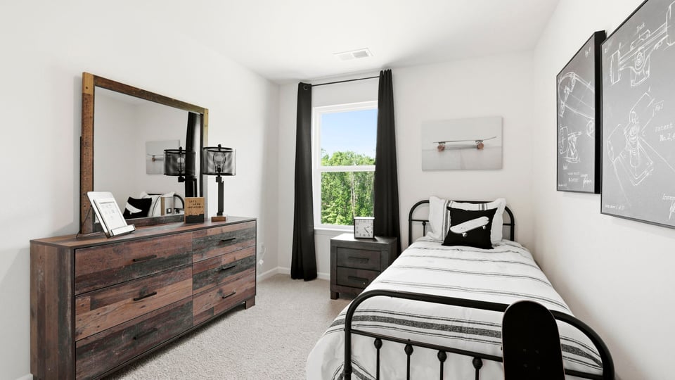 Bedroom with carpet and window.