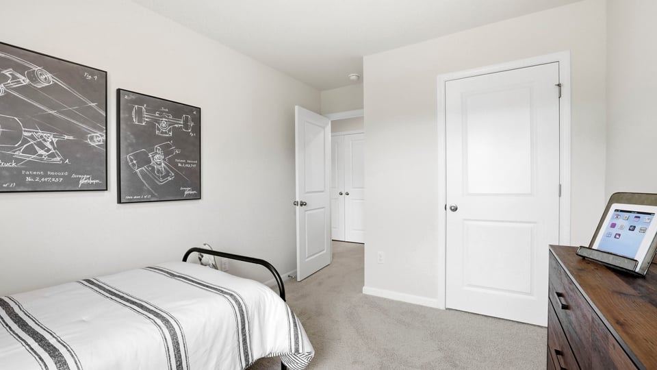 Bedroom with carpet and window.
