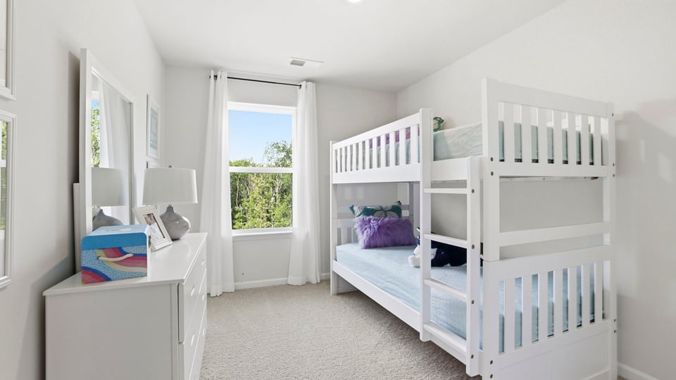 Bedroom with carpet and window.