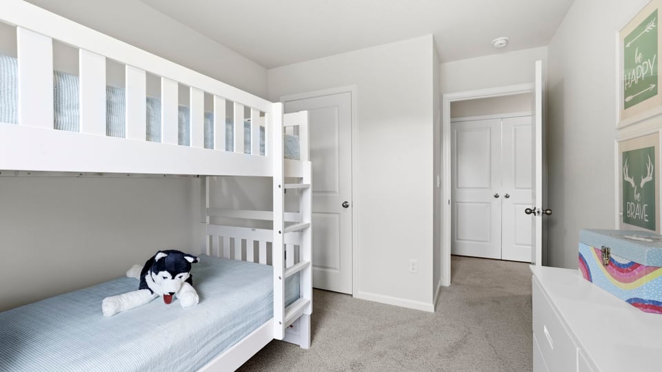 Bedroom with carpet and window.