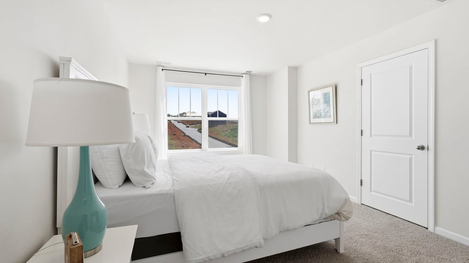 Bedroom with carpet and window.