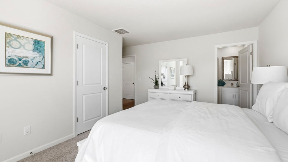 Bedroom with carpet and window.