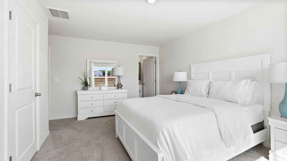 Bedroom with carpet and window.