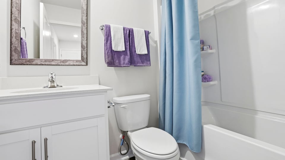 Bathroom with single vanity sink and tub.