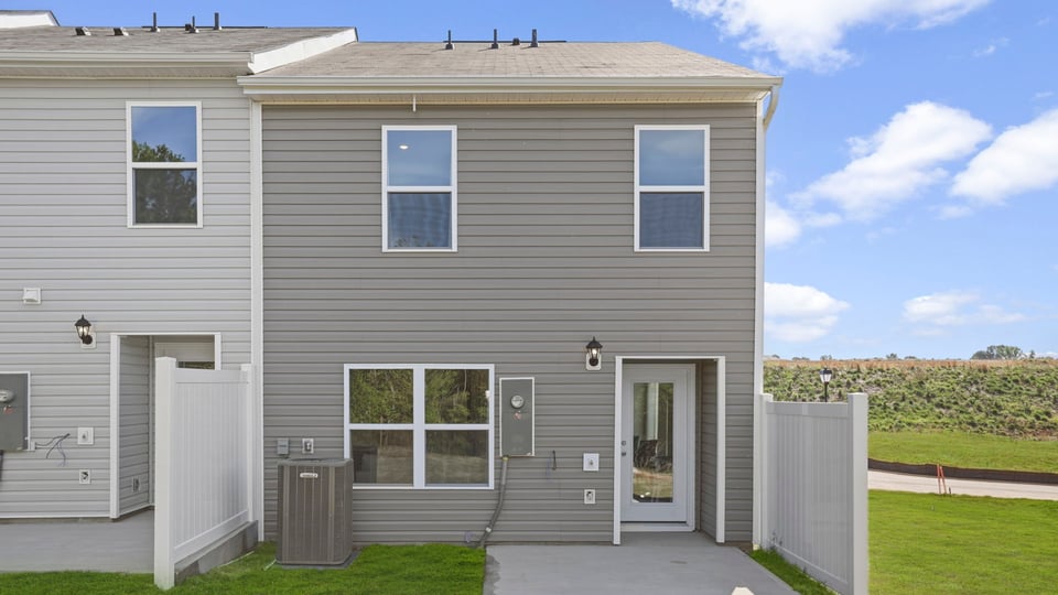 Back exterior of home with large backyard.