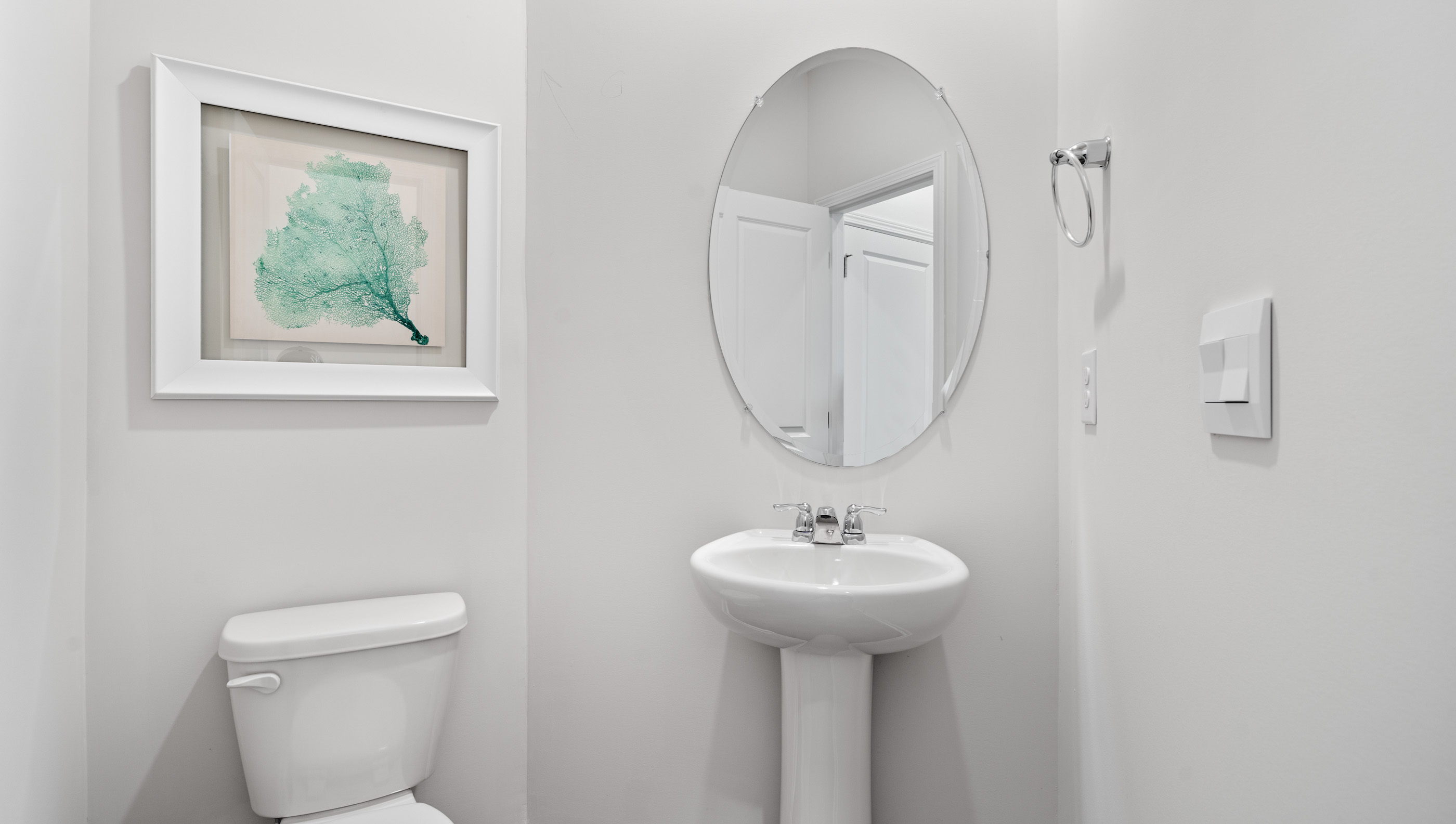 Half bathroom with mirror.