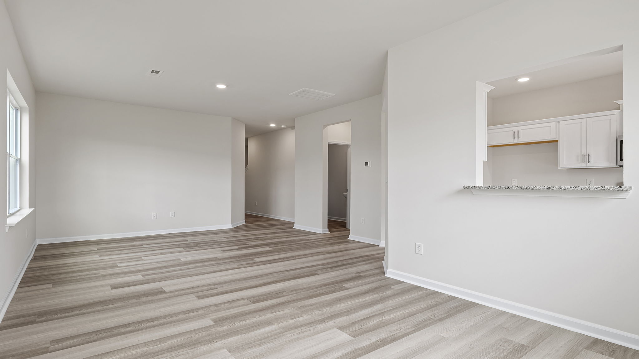 View of dining area and window into kitchen.