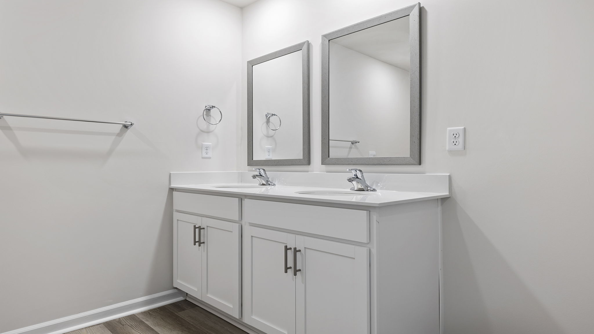 Primary bathroom dual sink vanity and mirrors.