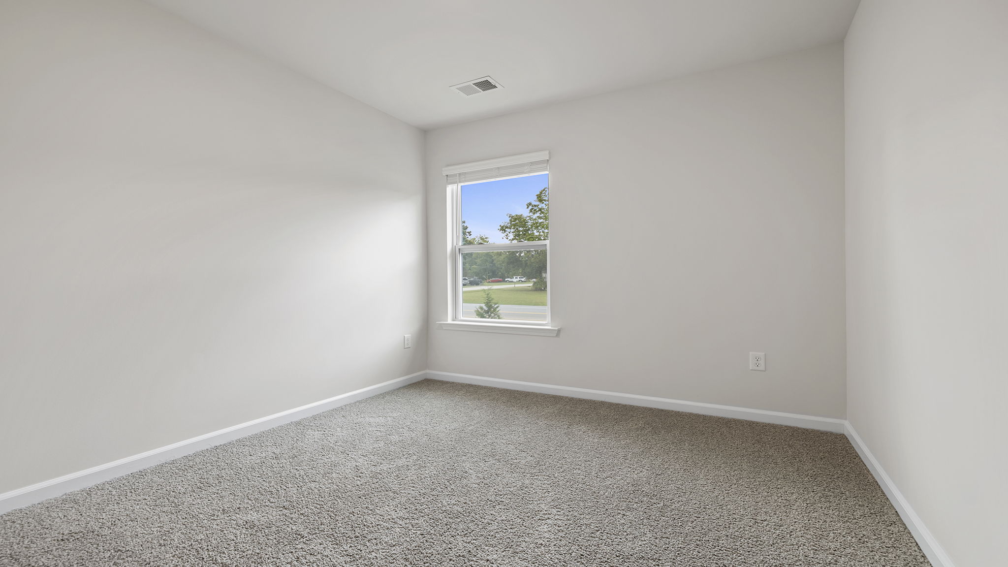 Bedroom with window and carpet.