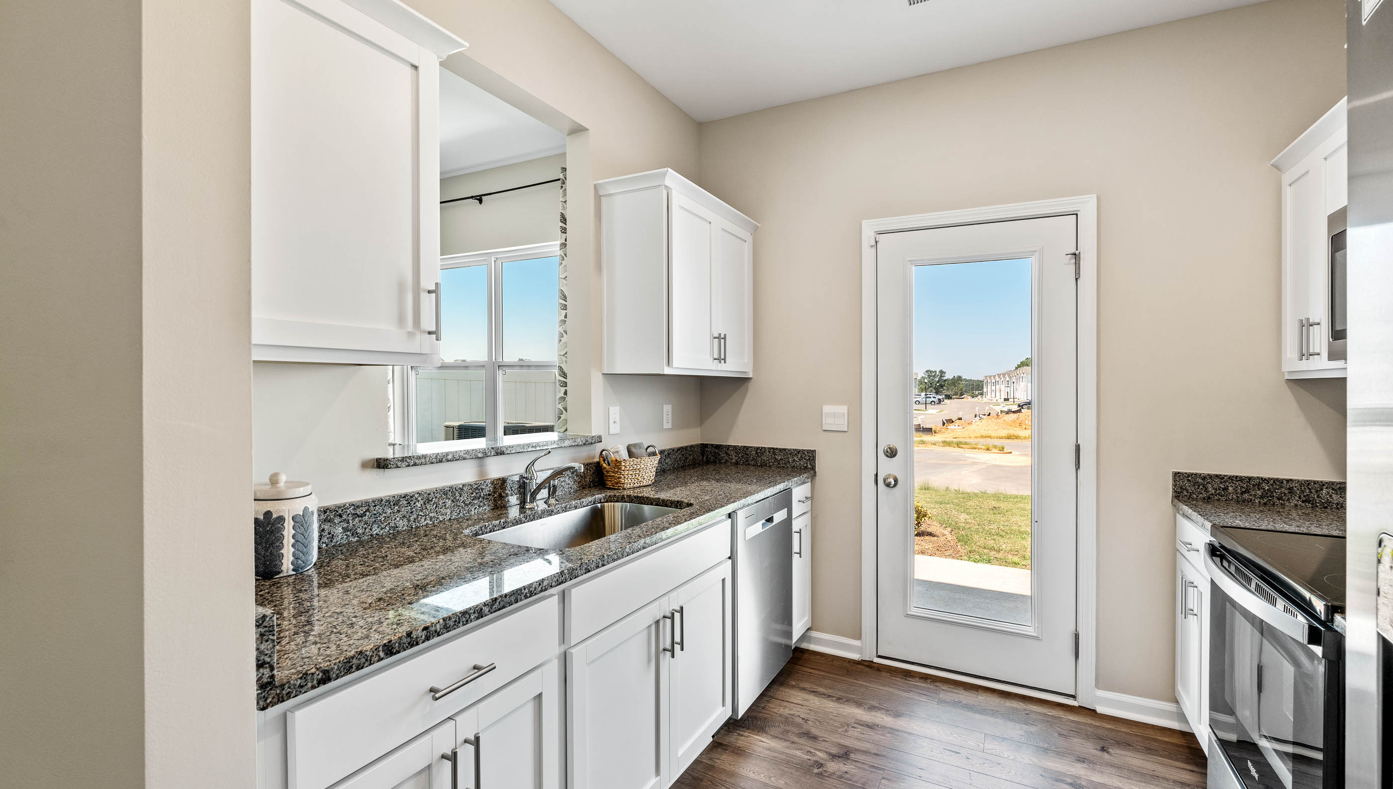 Kitchen with window and cabinets.