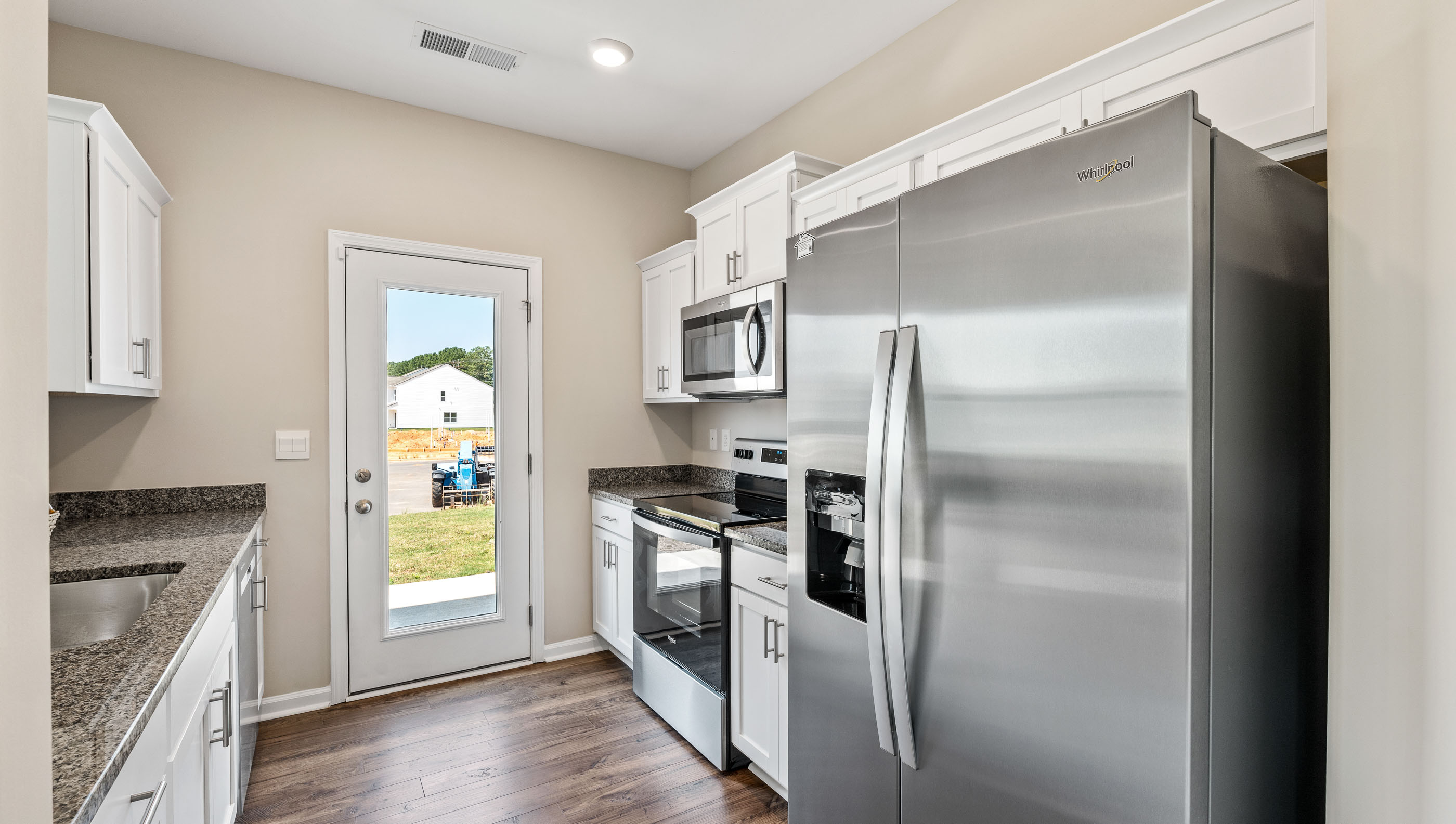 Kitchen with window and cabinets.
