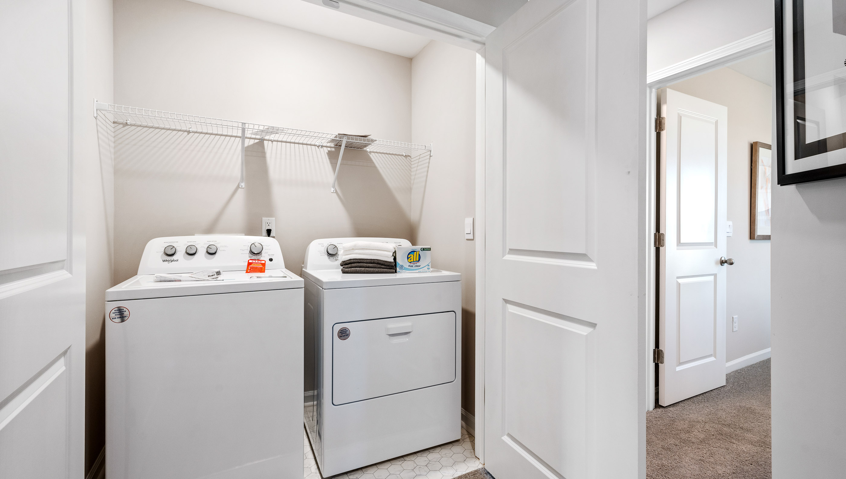 Laundry room with shelf.