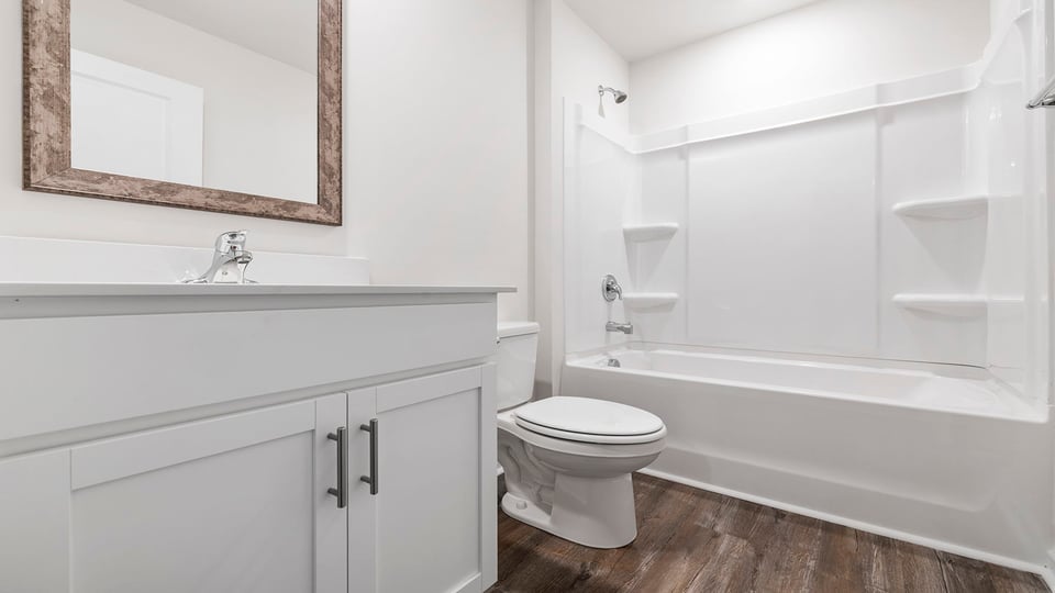 Hall bathroom with vanity and combination shower / tub.