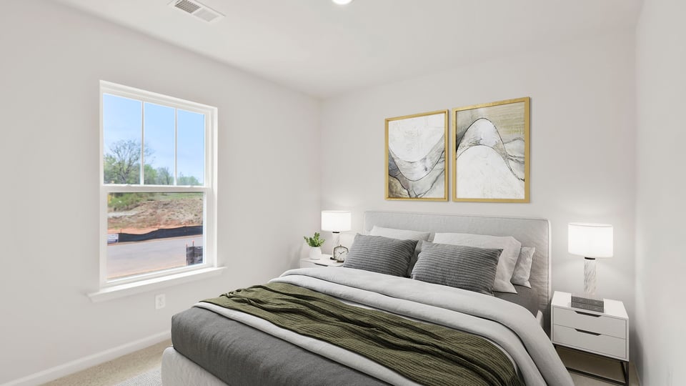 Bedroom with carpet and windows.