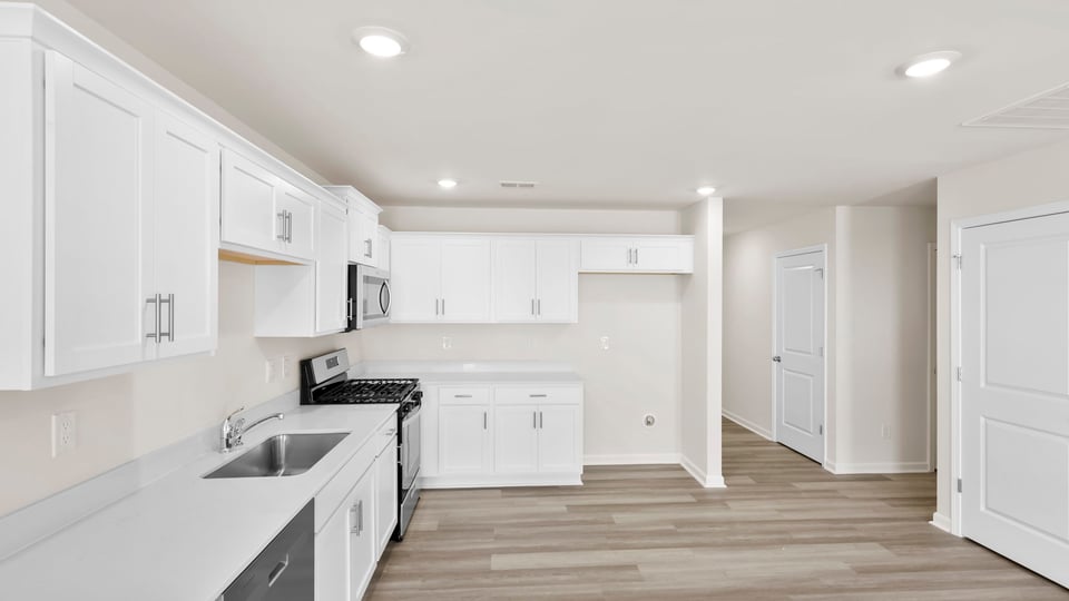 Kitchen with cabinets and windows.
