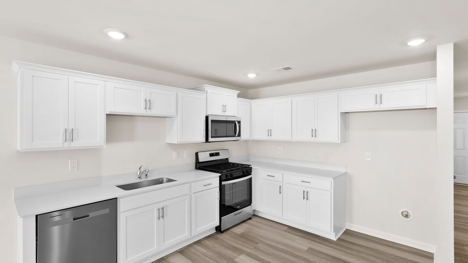 Kitchen with cabinets and windows.