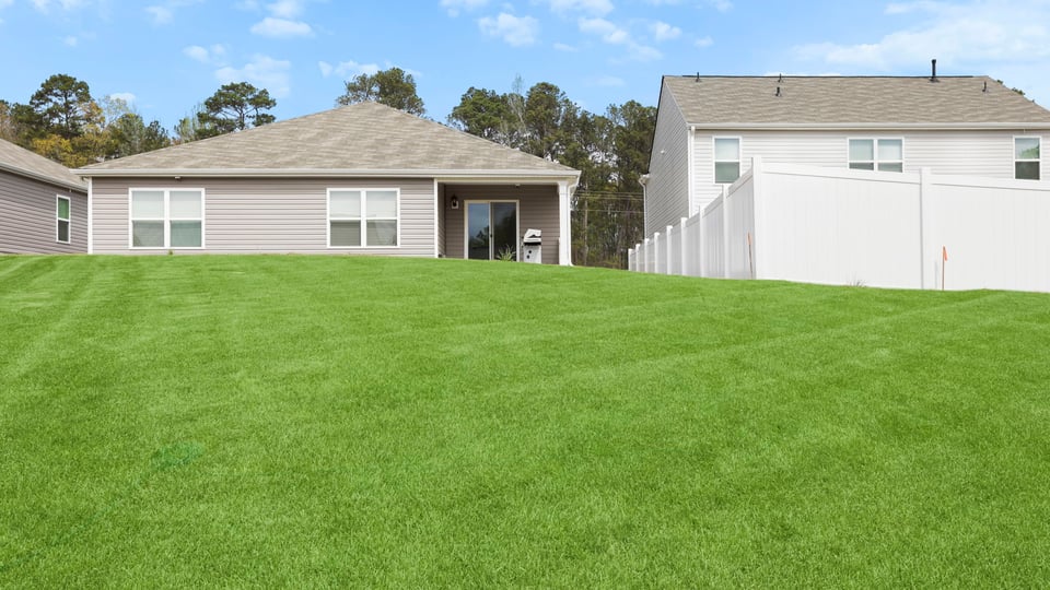 Back exterior with large backyard.