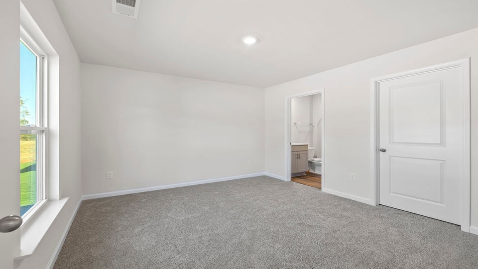 Primary bedroom with large window.