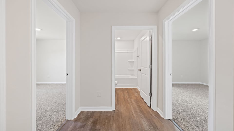 View of hallway, bathroom and bedroom entry.