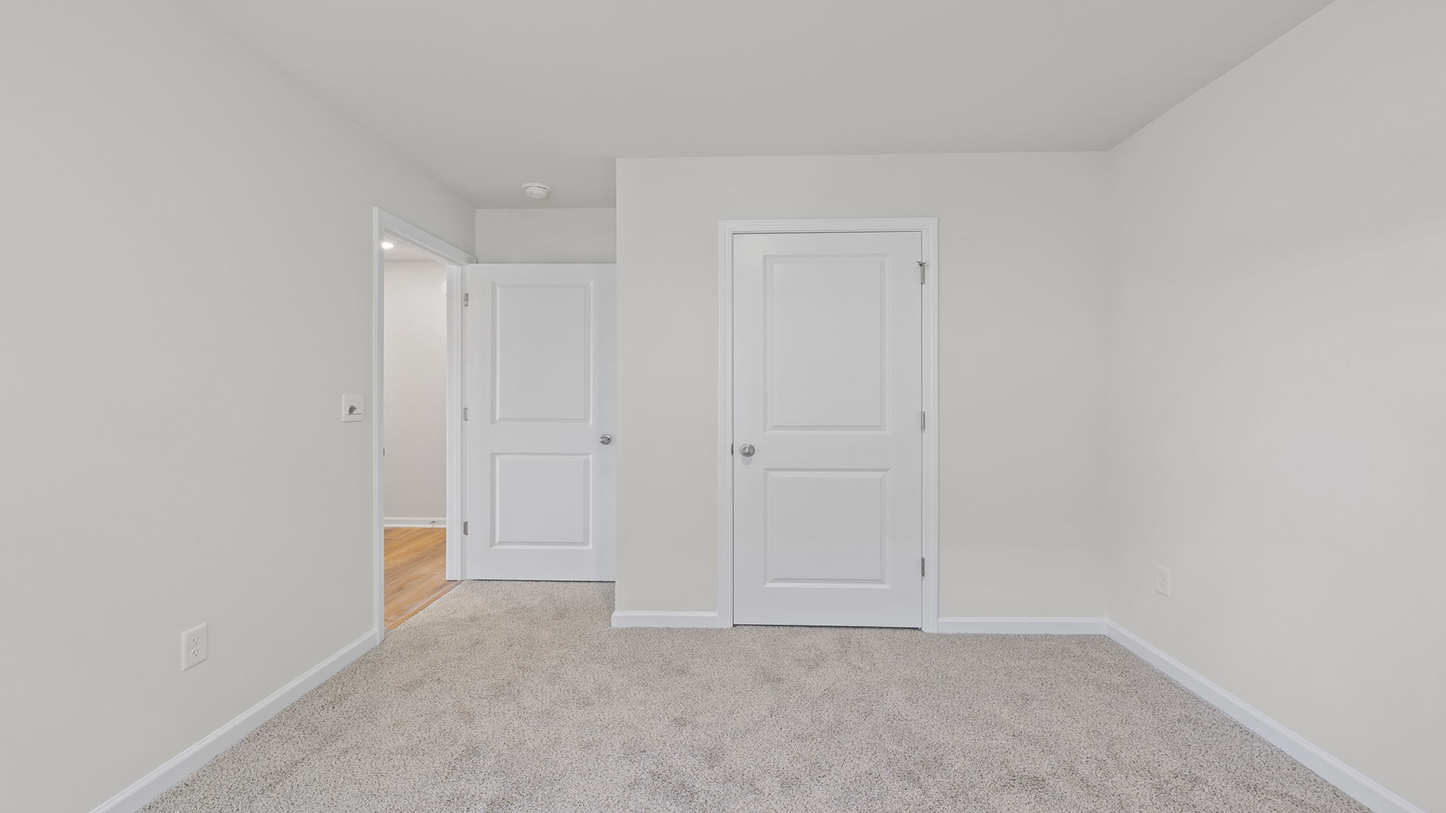 Bedroom with window and carpet.