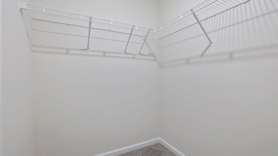 Primary closet with shelf.