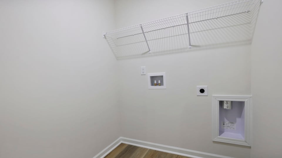 Laundry room with shelf.