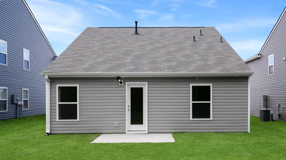 Back exterior with large backyard.
