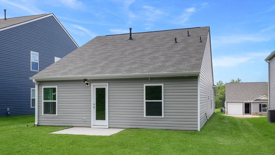 Back exterior with large backyard.