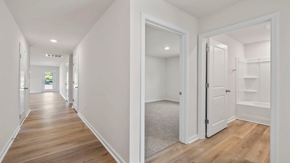 View of entrances to the hall bathroom and bedroomss.