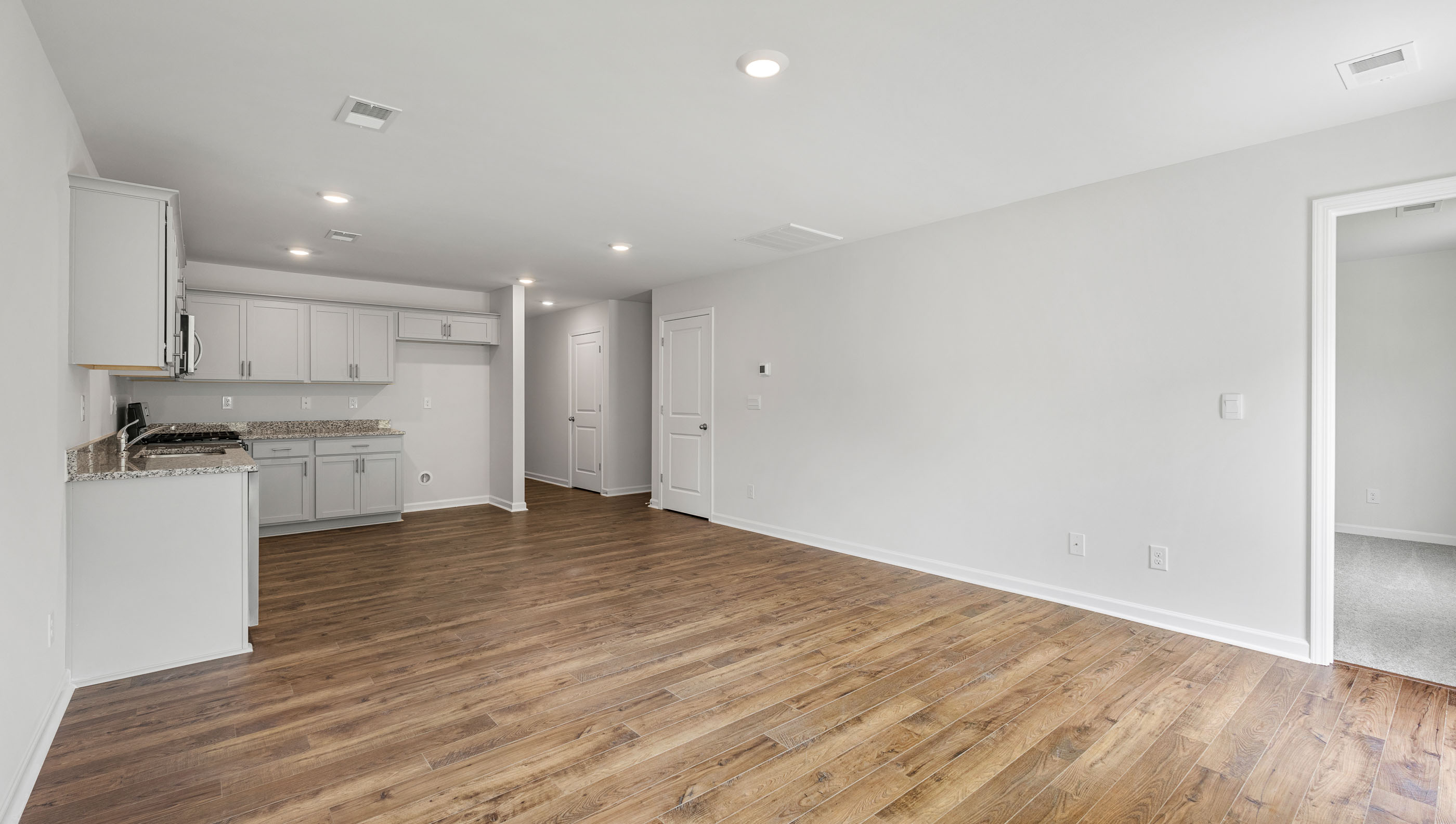 Living room with view of kitchen.