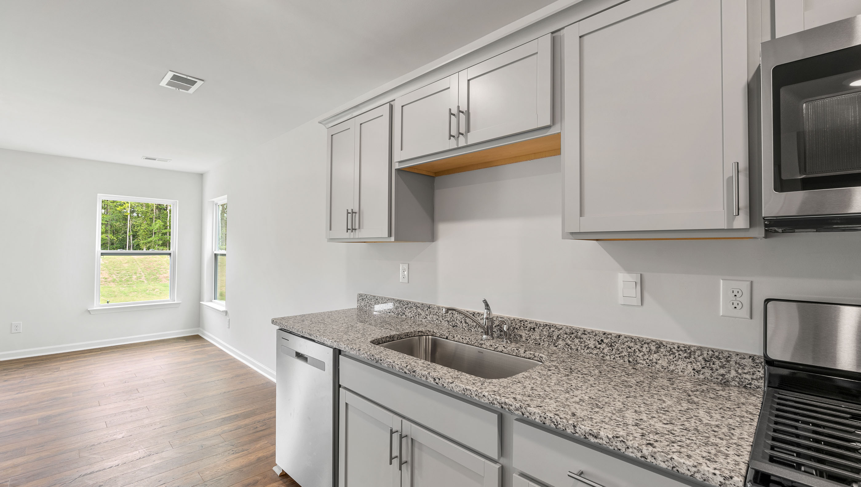 Kitchen with cabinets and window.