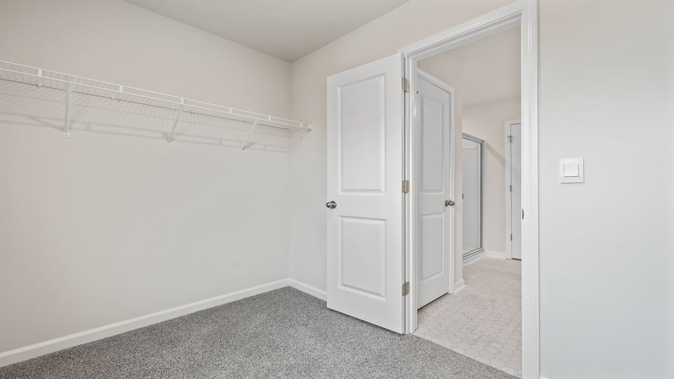 Primary bedroom walk-in closet.