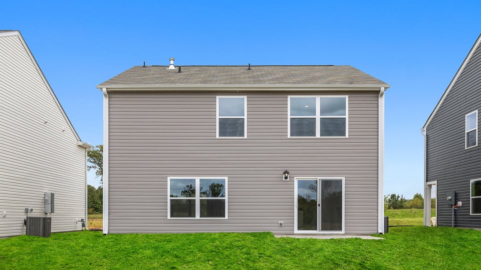 Back exterior view of home and patio.