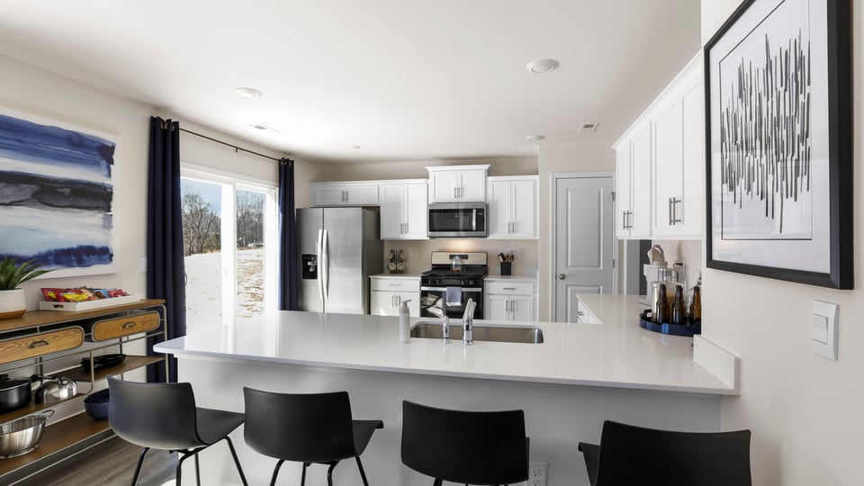 Kitchen with cabinets and windows.