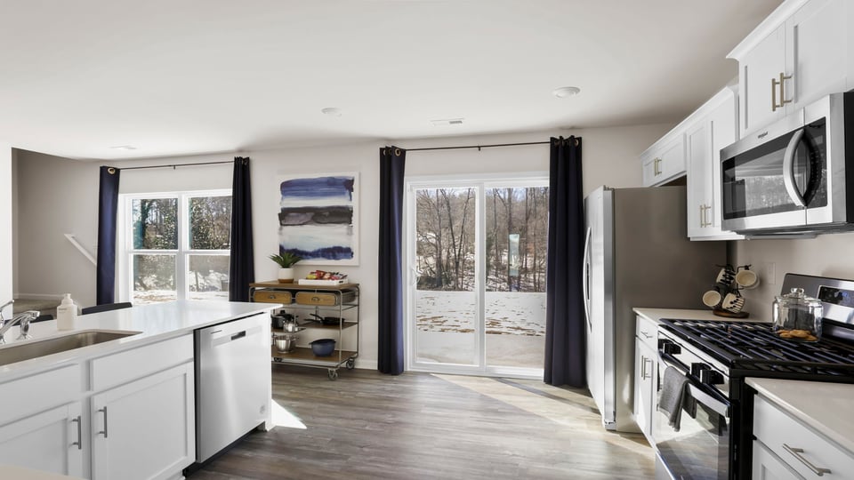 Kitchen with cabinets and windows.