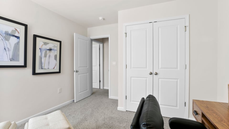 Bedroom with carpet and windows.