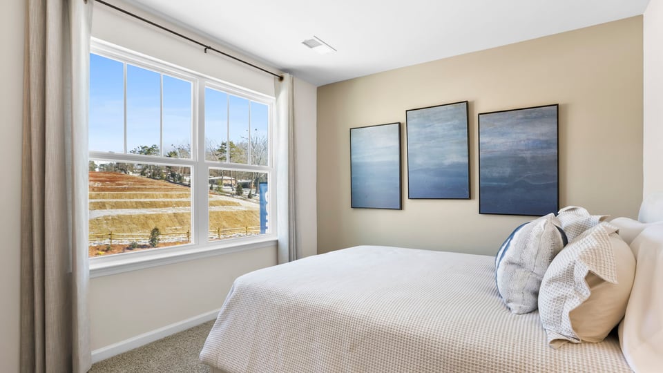Bedroom with carpet and windows.
