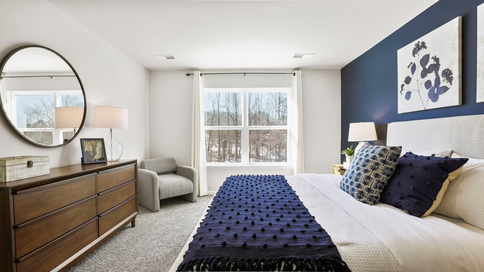 Bedroom with carpet and windows.