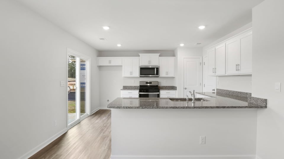 Kitchen with cabinet and window.