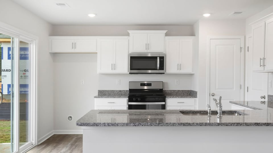 Kitchen with cabinet and window.