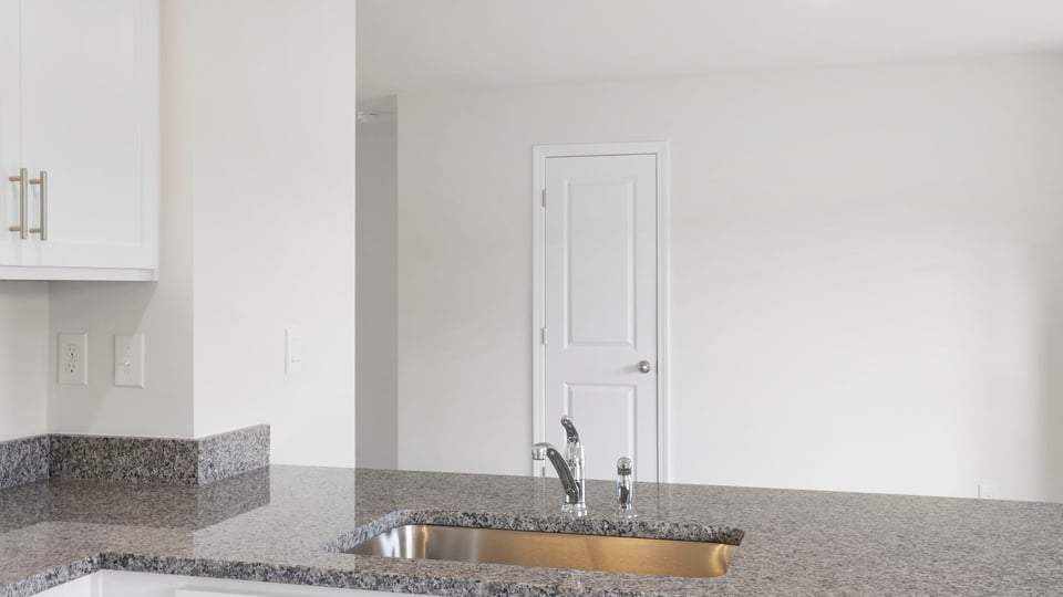 Kitchen with cabinet and window.