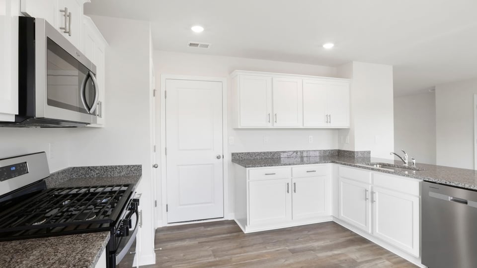 Kitchen with cabinet and window.