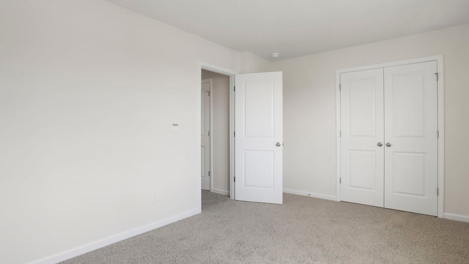 Bedroom with carpet and window,