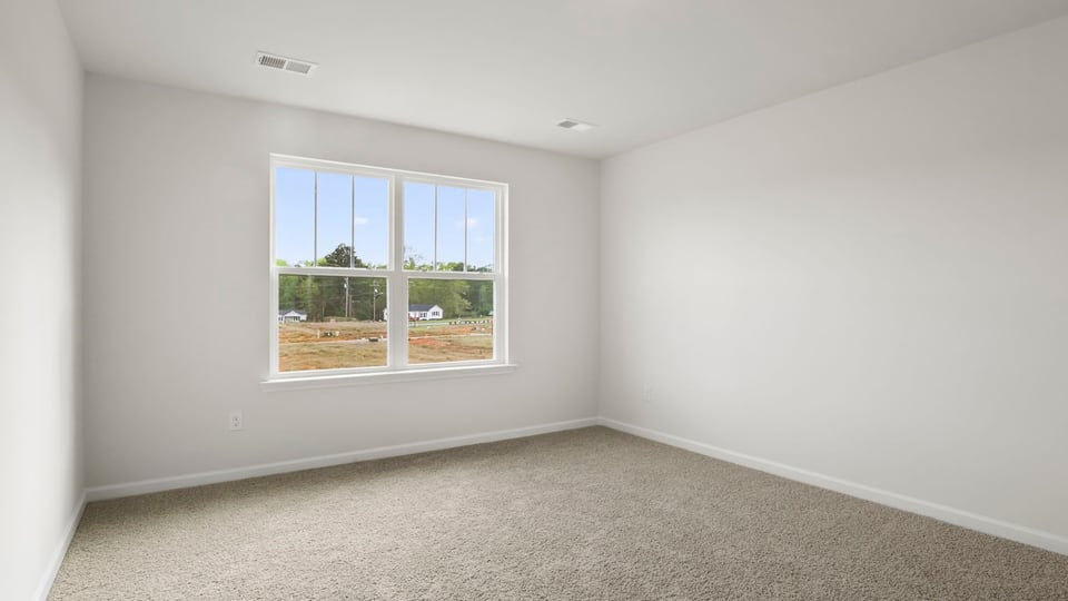 Bedroom with carpet and window,