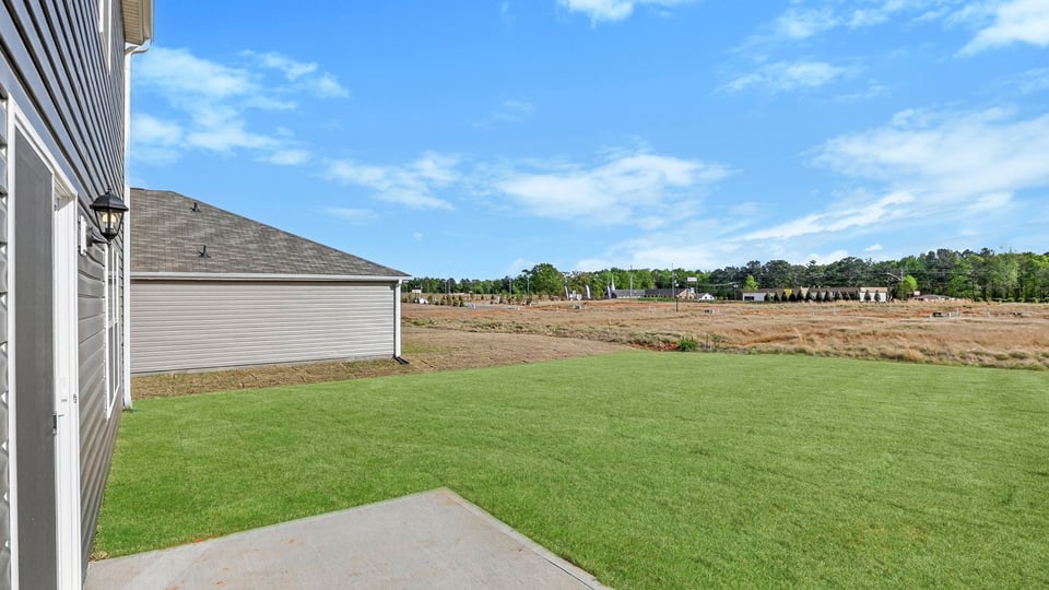 Back exterior with large backyard.