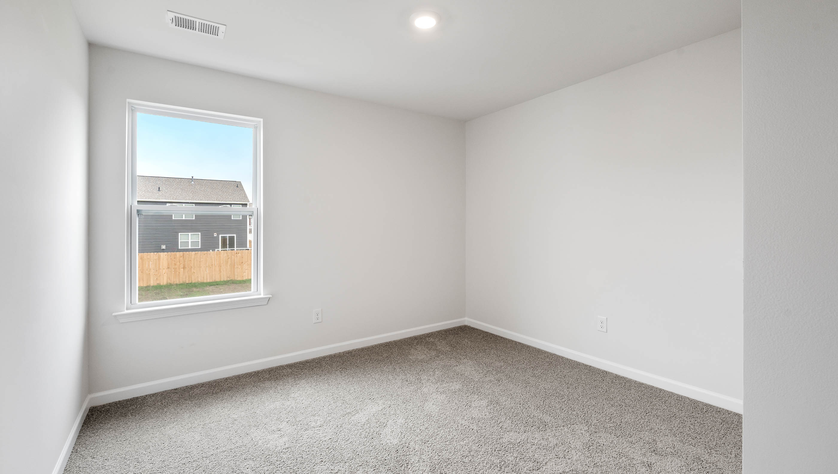 Bedroom with carpet and window.
