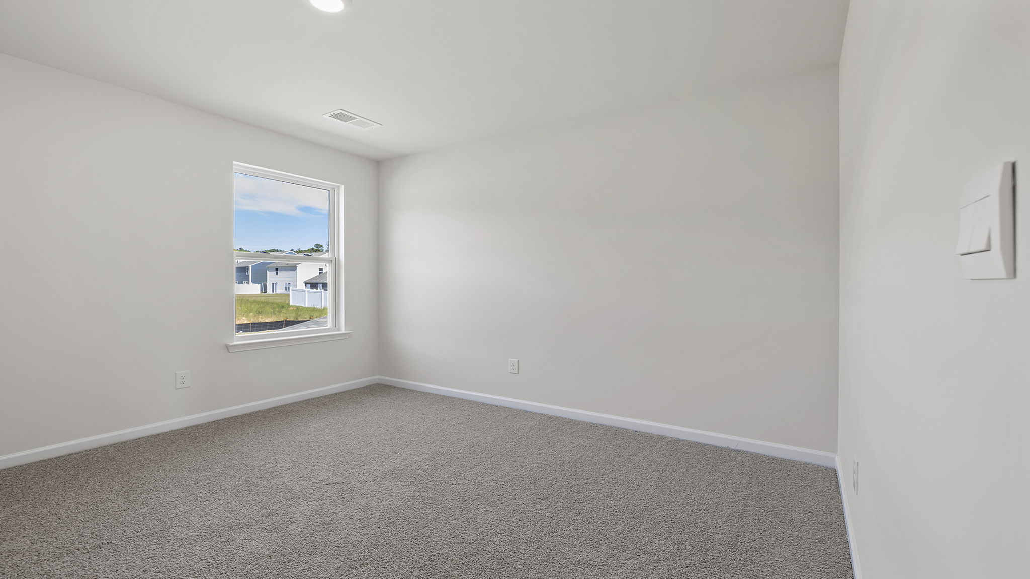 Bedroom with window and carpet.