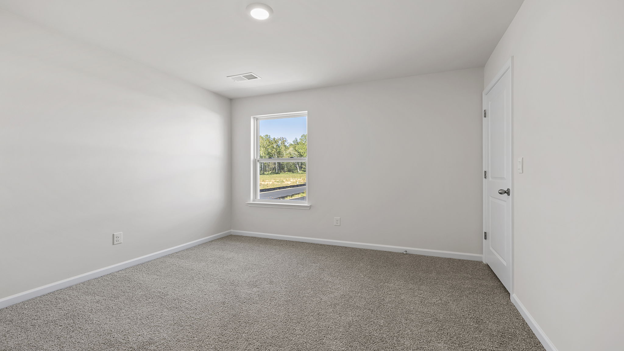 Bedroom with window and carpet.