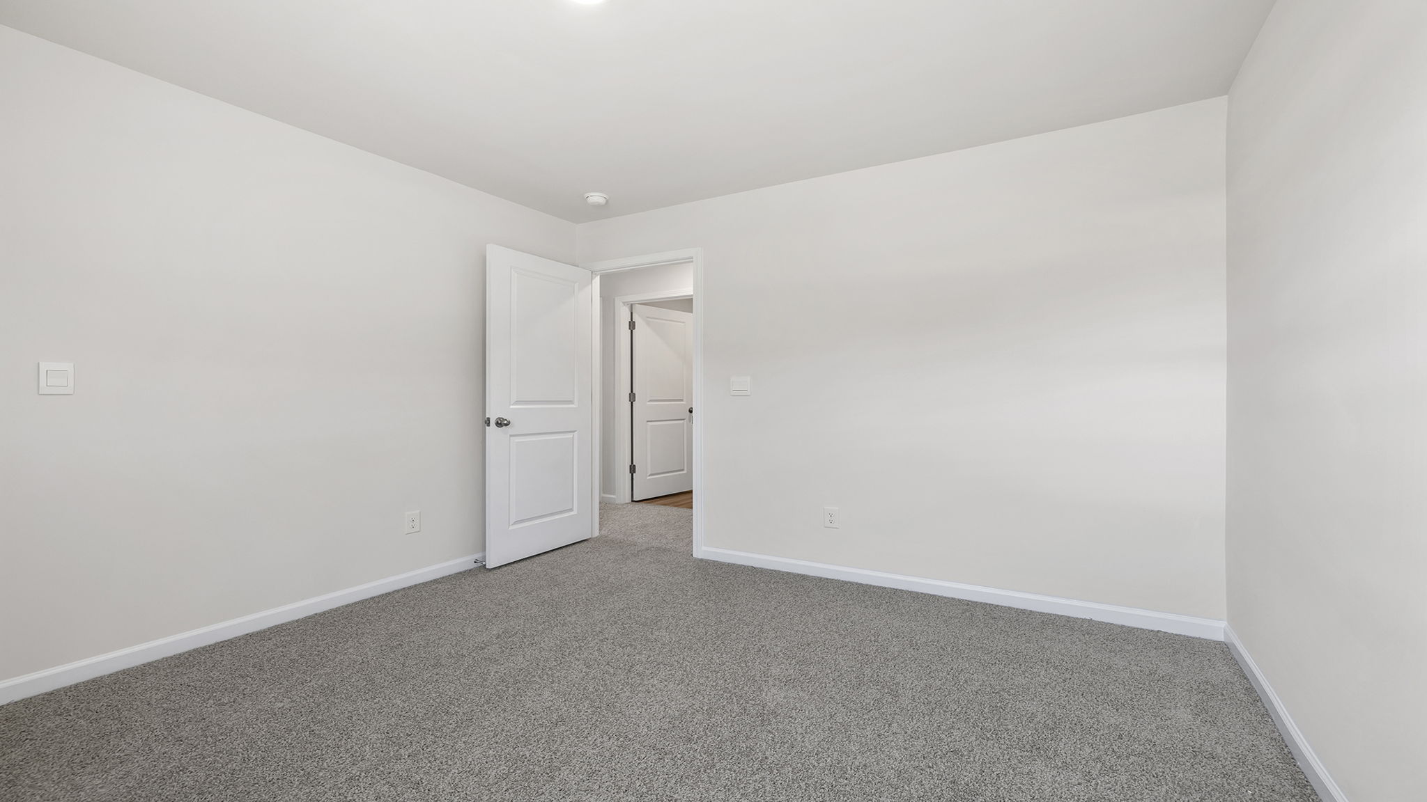 Bedroom with window and carpet.