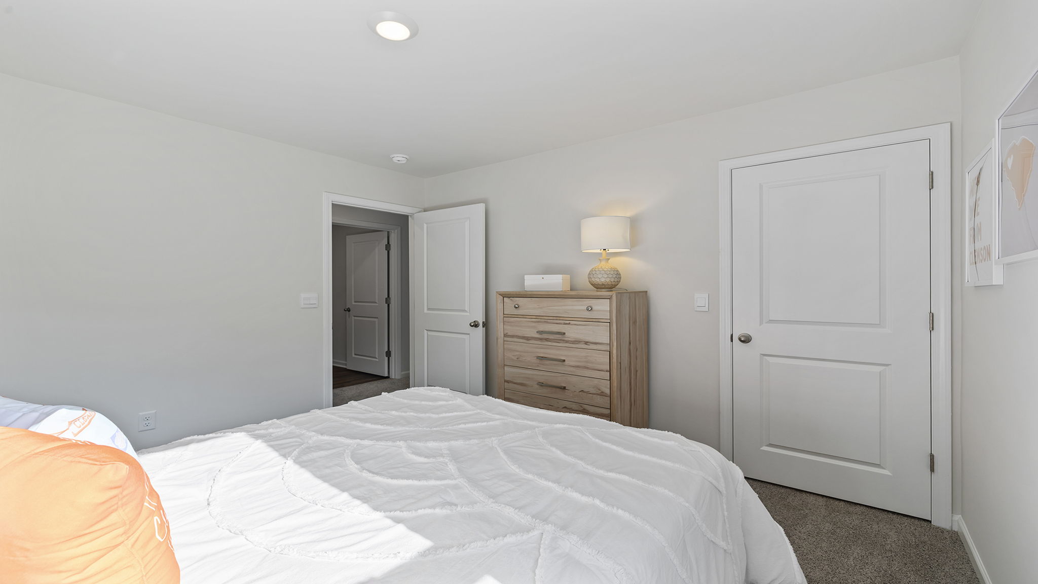 Bedroom with carpet and windows.